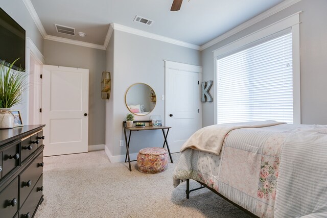 bedroom with light carpet, crown molding, and visible vents