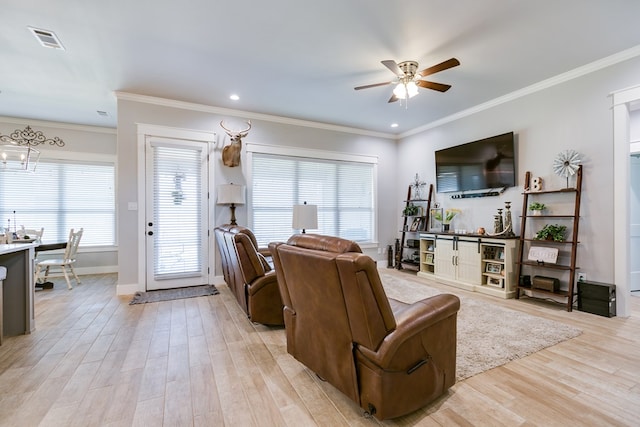 living room with light wood-type flooring, visible vents, crown molding, and ceiling fan