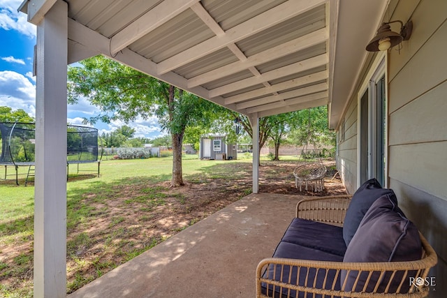 412 E Holmes Ave, Bronte, TX 76933 - view of patio / terrace with a trampoline and an outbuilding
