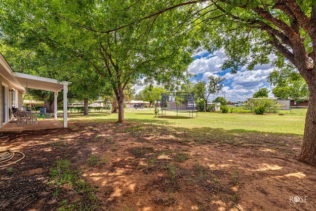 412 E Holmes Ave, Bronte, TX 76933 - fenced backyard with a trampoline and a patio
