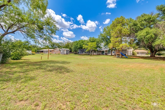 412 E Holmes Ave, Bronte, TX 76933 - view of yard with a playground, a trampoline, and a shed