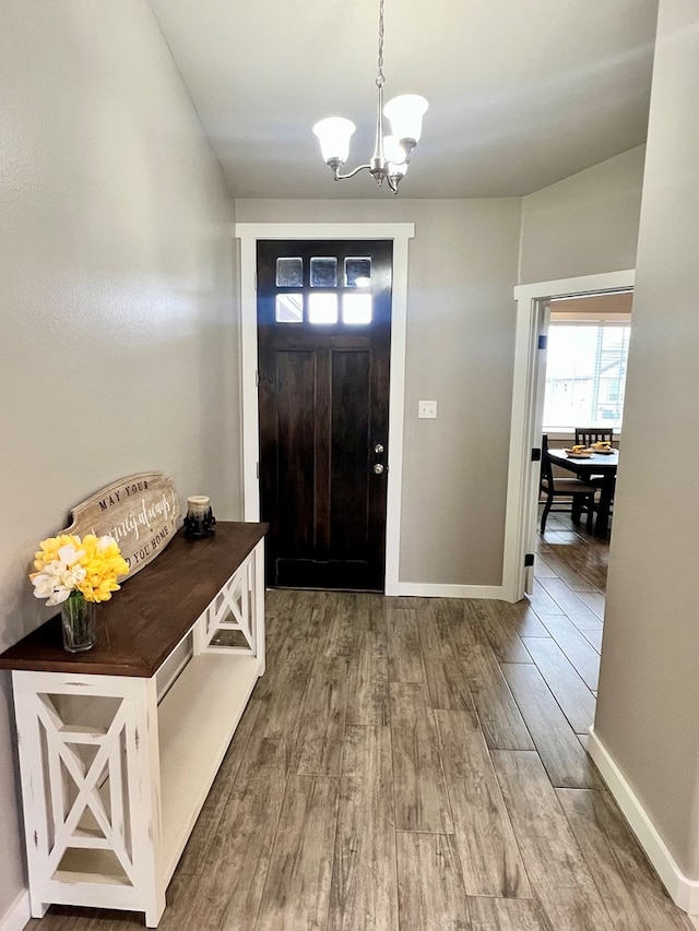 entryway featuring a notable chandelier and wood-type flooring