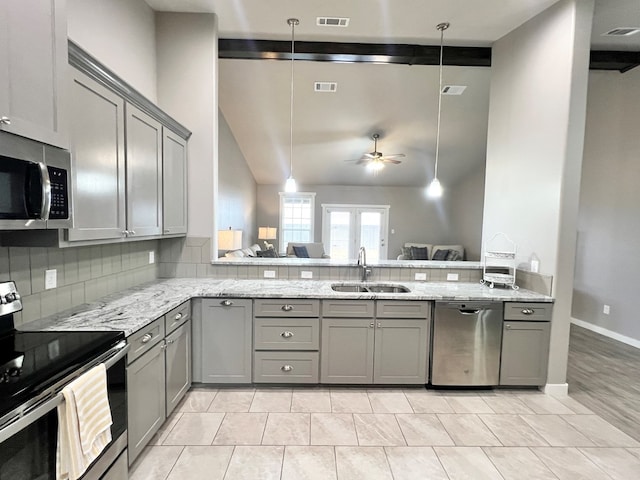 kitchen featuring sink, gray cabinetry, tasteful backsplash, pendant lighting, and stainless steel appliances