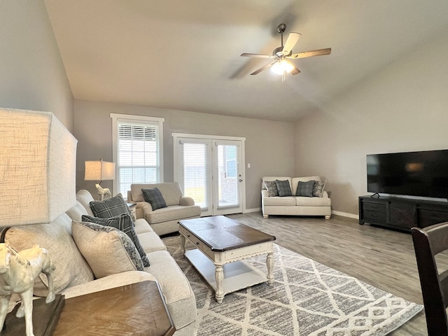 living room featuring lofted ceiling, hardwood / wood-style floors, and ceiling fan