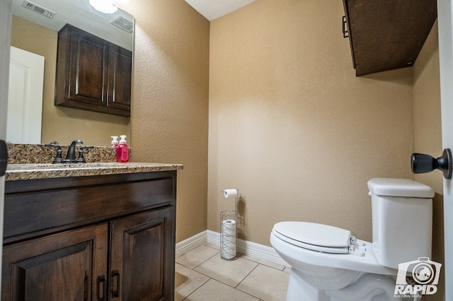 bathroom featuring tile patterned floors, toilet, and vanity