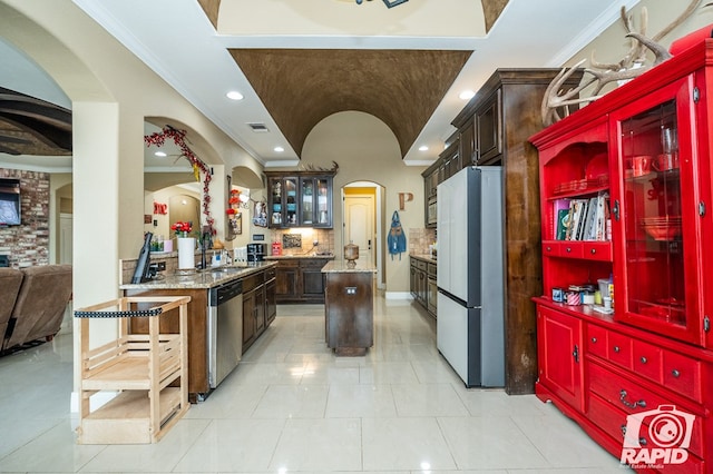 kitchen with fridge, crown molding, dishwasher, and a kitchen island