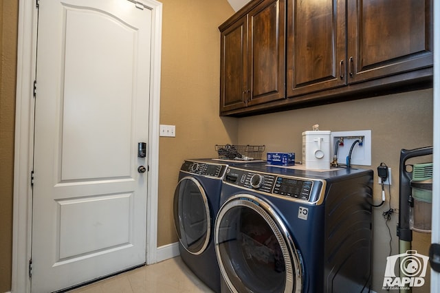 laundry room with cabinets and washer and clothes dryer