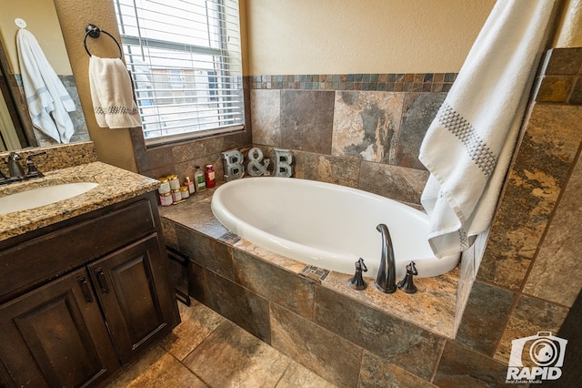 bathroom with vanity and a relaxing tiled tub