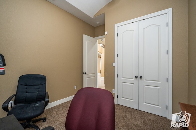 home office featuring lofted ceiling and carpet flooring