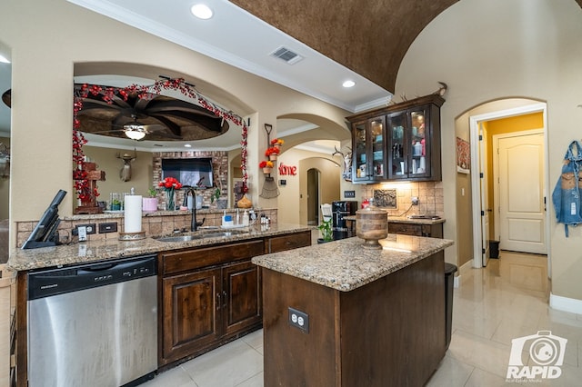 kitchen with dishwasher, a kitchen island, sink, and kitchen peninsula