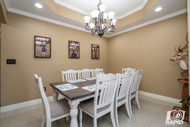 dining space with crown molding, a chandelier, a raised ceiling, and light tile patterned floors