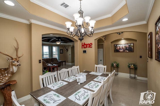 dining area featuring ceiling fan with notable chandelier, ornamental molding, and a raised ceiling