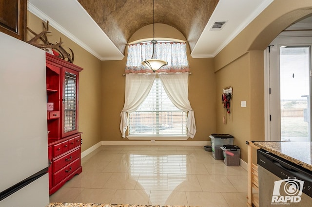 dining space with lofted ceiling, ornamental molding, and light tile patterned flooring