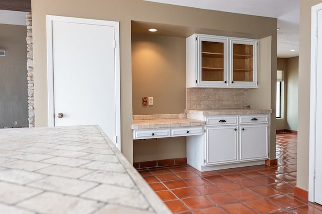 3705 Gemini Dr, San Angelo, TX 76903 - kitchen featuring white cabinetry, dark tile patterned flooring, light countertops, and glass insert cabinets