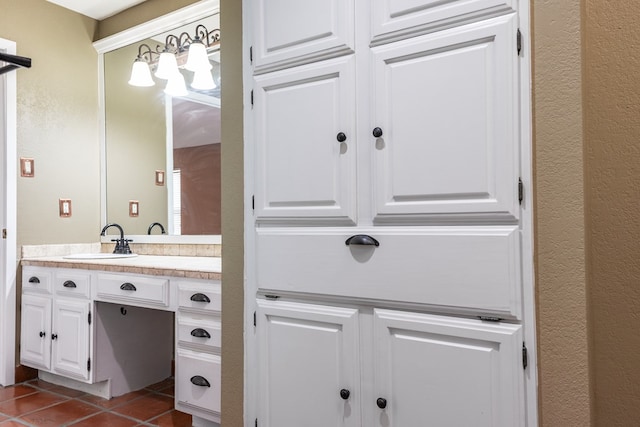3705 Gemini Dr, San Angelo, TX 76903 - bathroom with tile patterned flooring, a textured wall, and vanity