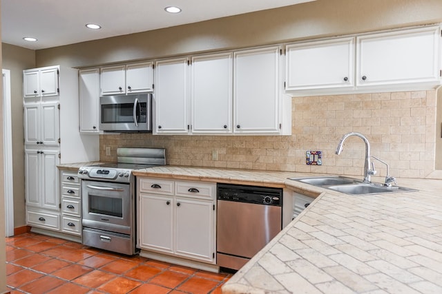 3705 Gemini Dr, San Angelo, TX 76903 - kitchen with tasteful backsplash, stainless steel appliances, white cabinets, and a sink