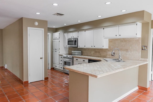 3705 Gemini Dr, San Angelo, TX 76903 - kitchen featuring tasteful backsplash, a sink, appliances with stainless steel finishes, visible vents, and light countertops