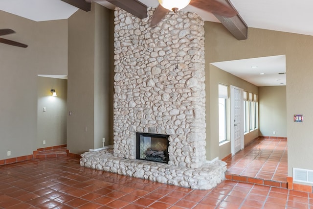3705 Gemini Dr, San Angelo, TX 76903 - unfurnished living room with tile patterned flooring, a fireplace, beam ceiling, visible vents, and a ceiling fan