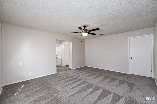 spare room with ceiling fan, carpet floors, and a textured ceiling