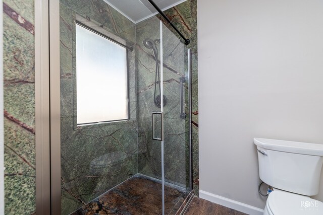 bathroom with wood-type flooring, an enclosed shower, and toilet