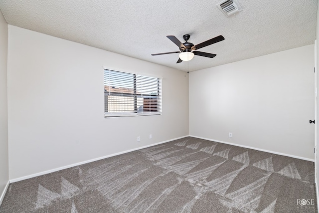 empty room with ceiling fan, carpet floors, and a textured ceiling