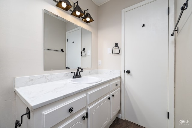 bathroom featuring hardwood / wood-style flooring and vanity