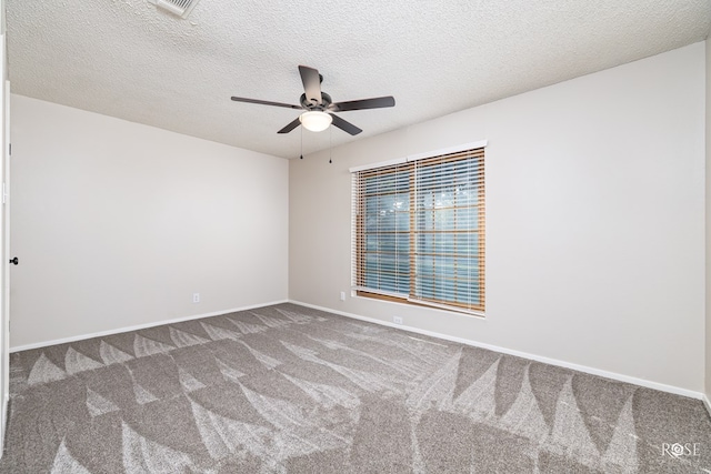 unfurnished room with ceiling fan, carpet floors, and a textured ceiling