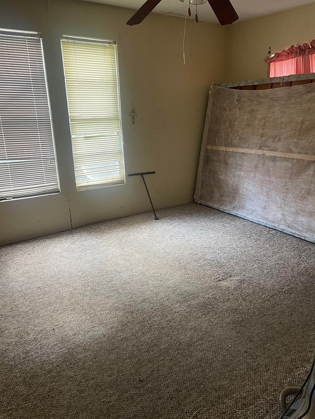 carpeted empty room with ceiling fan