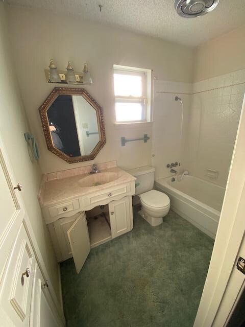 full bathroom featuring shower / tub combination, vanity, a textured ceiling, and toilet