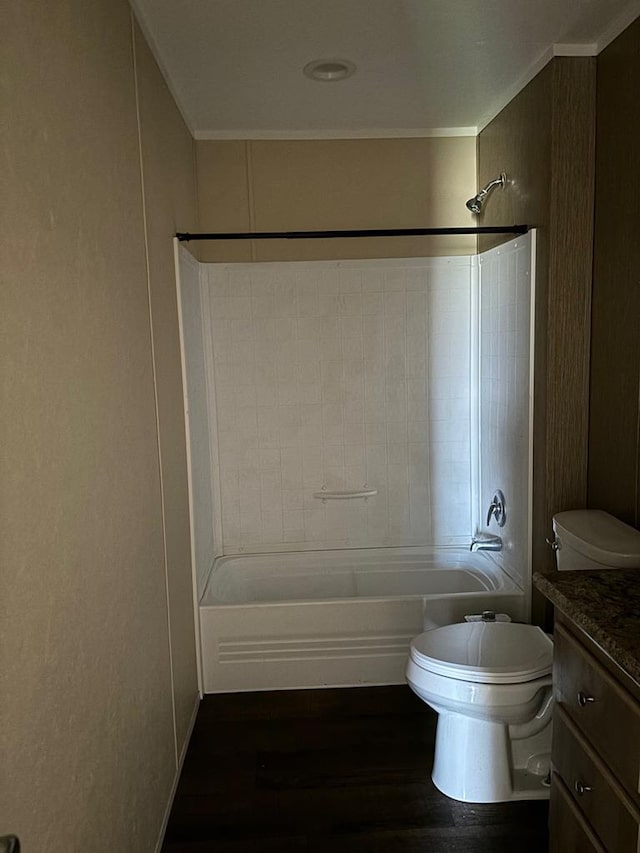 full bathroom featuring crown molding, hardwood / wood-style floors, vanity, bathtub / shower combination, and toilet