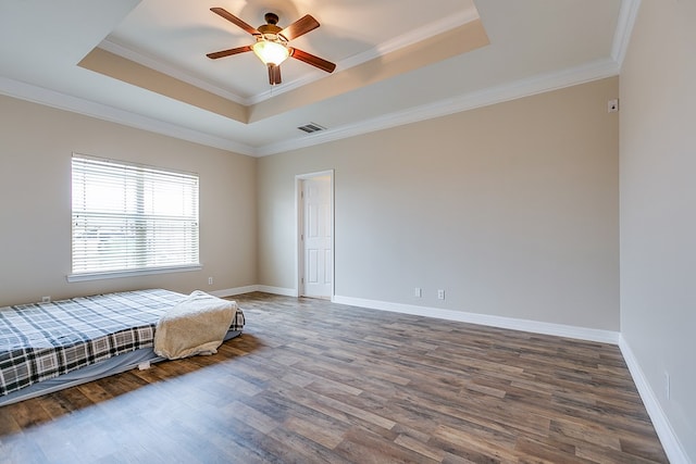 4333 Chisholm Trl, San Angelo, TX 76903 - bedroom featuring a raised ceiling, wood finished floors, crown molding, and baseboards