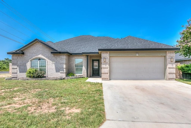 4333 Chisholm Trl, San Angelo, TX 76903 - view of front of property featuring brick siding, a front lawn, driveway, an attached garage, and roof with shingles