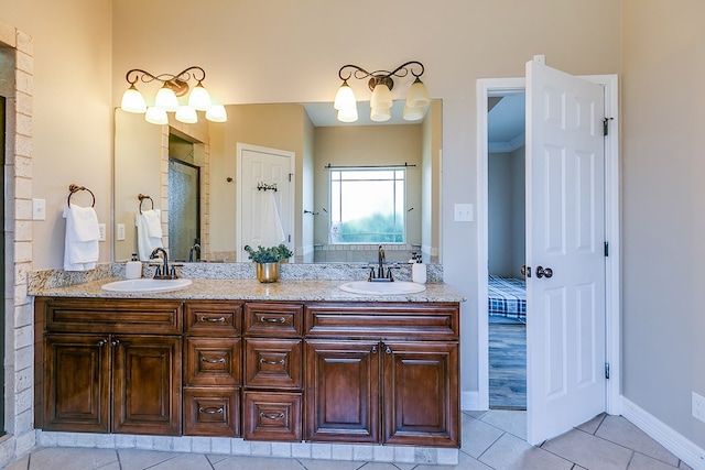 4333 Chisholm Trl, San Angelo, TX 76903 - full bath featuring tile patterned flooring, double vanity, an enclosed shower, ensuite bath, and baseboards