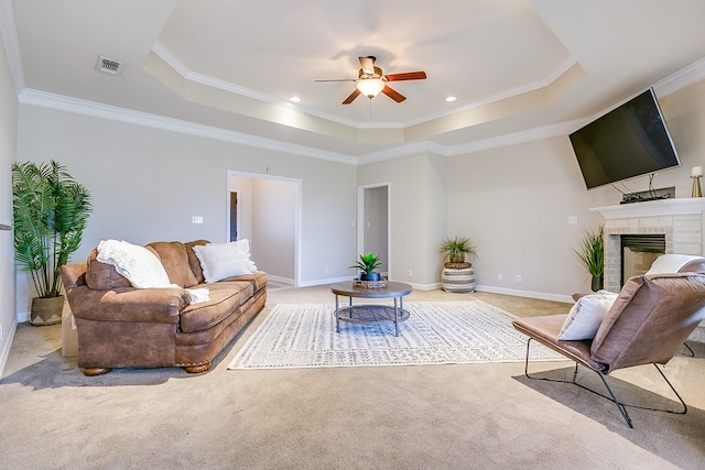 4333 Chisholm Trl, San Angelo, TX 76903 - living room with a raised ceiling, light carpet, a ceiling fan, a brick fireplace, and ornamental molding