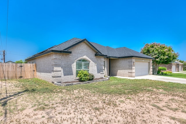 4333 Chisholm Trl, San Angelo, TX 76903 - french country home featuring brick siding, an attached garage, and concrete driveway