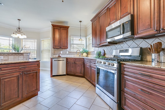 4333 Chisholm Trl, San Angelo, TX 76903 - kitchen with stainless steel appliances, backsplash, hanging light fixtures, light tile patterned floors, and ornamental molding