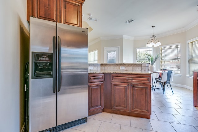 4333 Chisholm Trl, San Angelo, TX 76903 - kitchen with stainless steel fridge with ice dispenser, a chandelier, ornamental molding, light tile patterned floors, and light stone counters