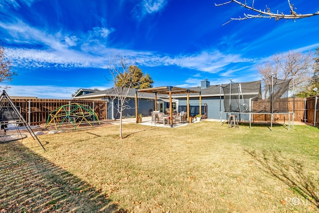 rear view of house featuring a yard, a playground, a patio area, and a trampoline