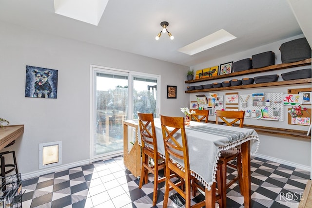 dining room with a skylight