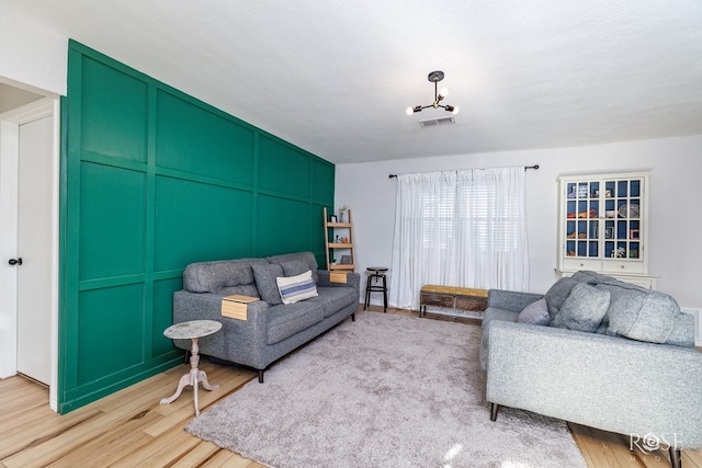 living room with light hardwood / wood-style flooring and a textured ceiling