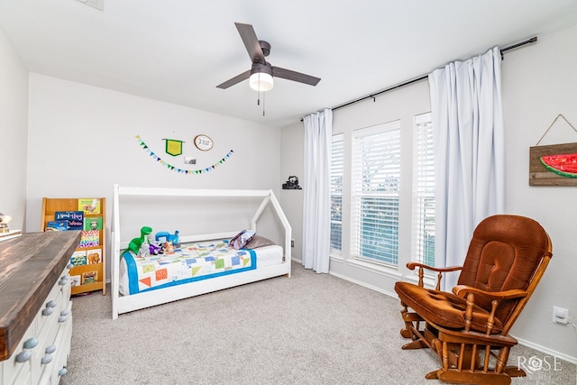 bedroom with multiple windows, light colored carpet, and ceiling fan