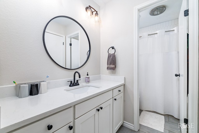 bathroom featuring vanity and curtained shower