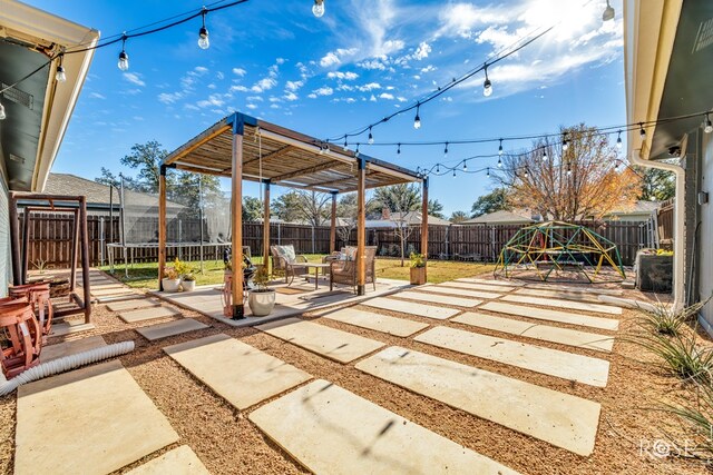 view of patio featuring a playground and a trampoline