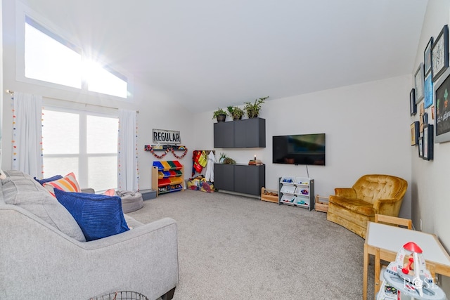 carpeted living room featuring vaulted ceiling