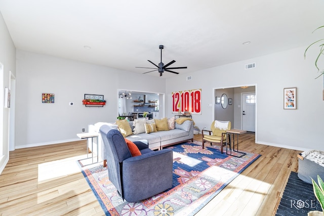 living room with ceiling fan and light hardwood / wood-style flooring