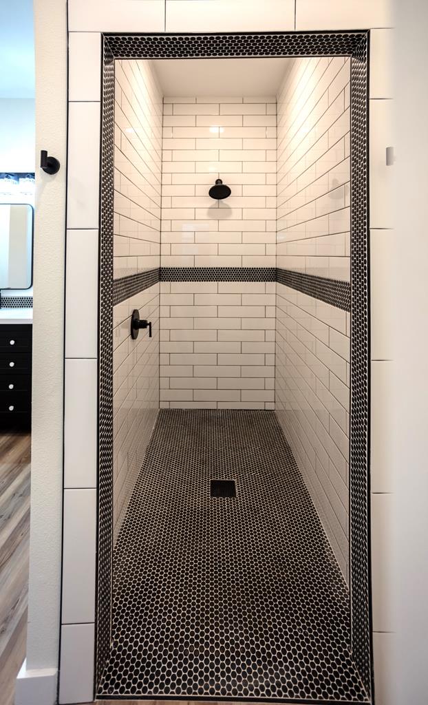 full bathroom featuring a shower stall and vanity