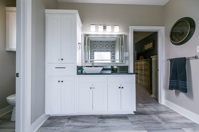 bathroom featuring vanity and toilet