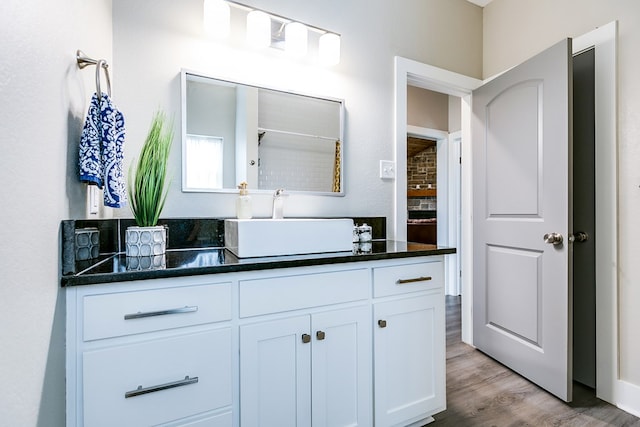 bathroom with vanity, hardwood / wood-style floors, and curtained shower