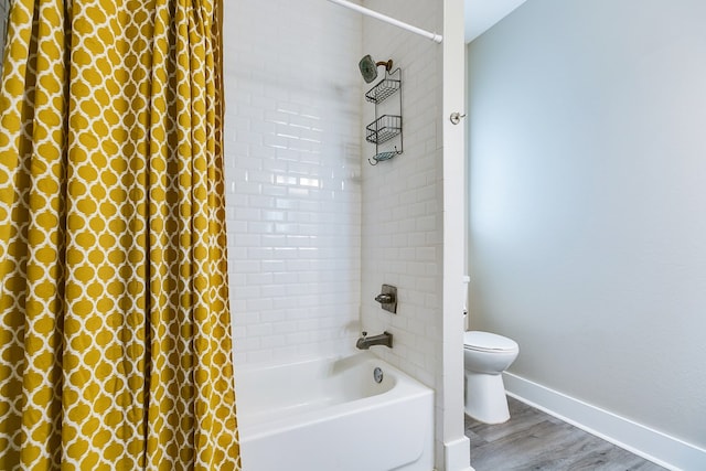 bathroom with wood-type flooring, shower / bath combination with curtain, and toilet