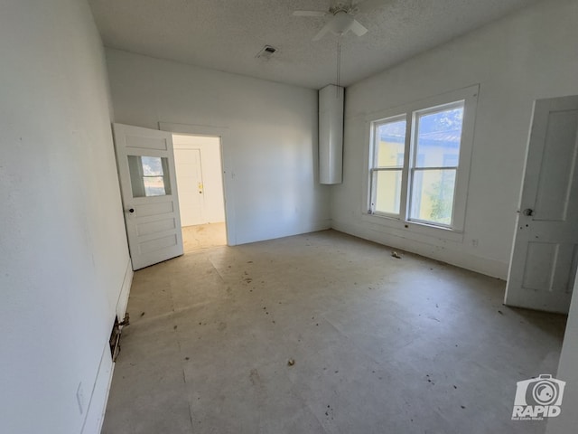 901 S Walnut St, Brady, TX 76825 - spare room with ceiling fan, unfinished concrete floors, and a textured ceiling